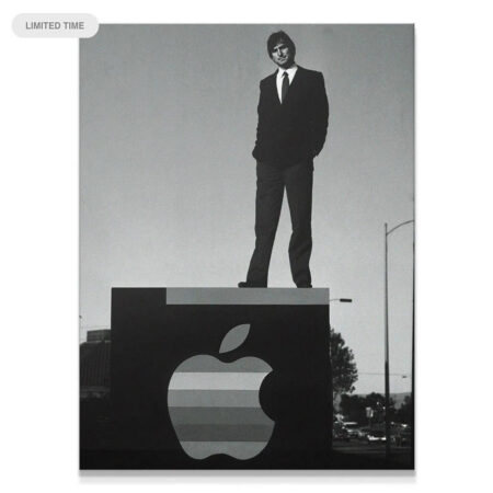 Full shot of Steve Jobs 'Standing On Business' atop the massive corporate sign, representing ambition.