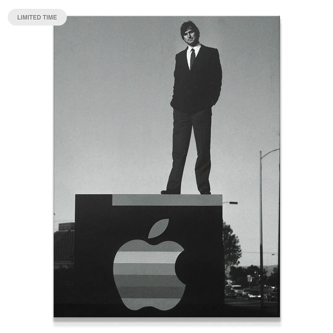 Full shot of Steve Jobs 'Standing On Business' atop the massive corporate sign, representing ambition.