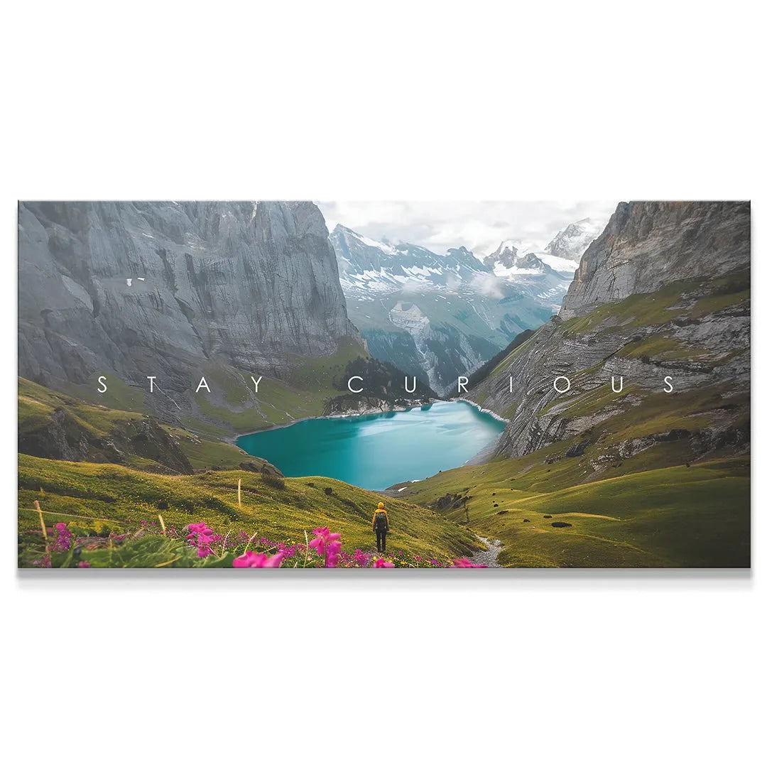 Panoramic landscape canvas featuring the text 'Stay Curious' over a turquoise alpine lake.