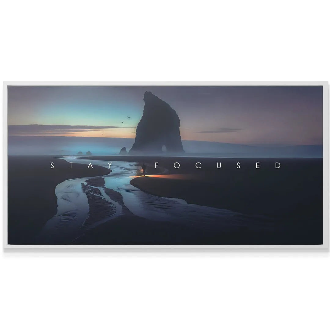 Panoramic shot of the towering sea stack silhouette framed by the inspiring "Stay Focused" text overlay.