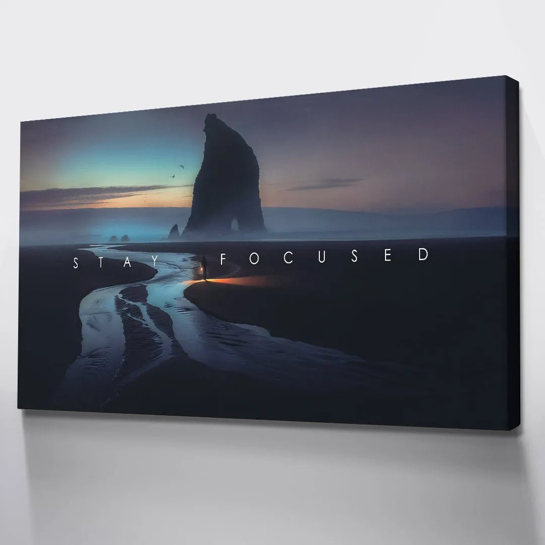 Extreme close-up on the white, bold lettering of the phrase "Stay Focused" against the dark photographic background.