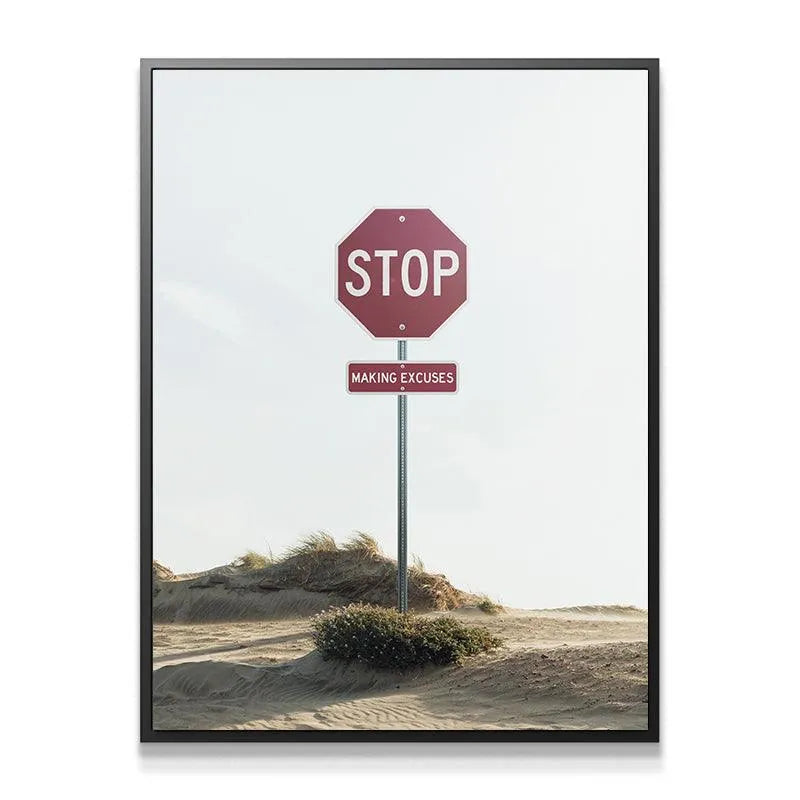 Detailed close-up of the red octagon stop sign and the rectangular 'MAKING EXCUSES' plaque under a bright, overcast sky.