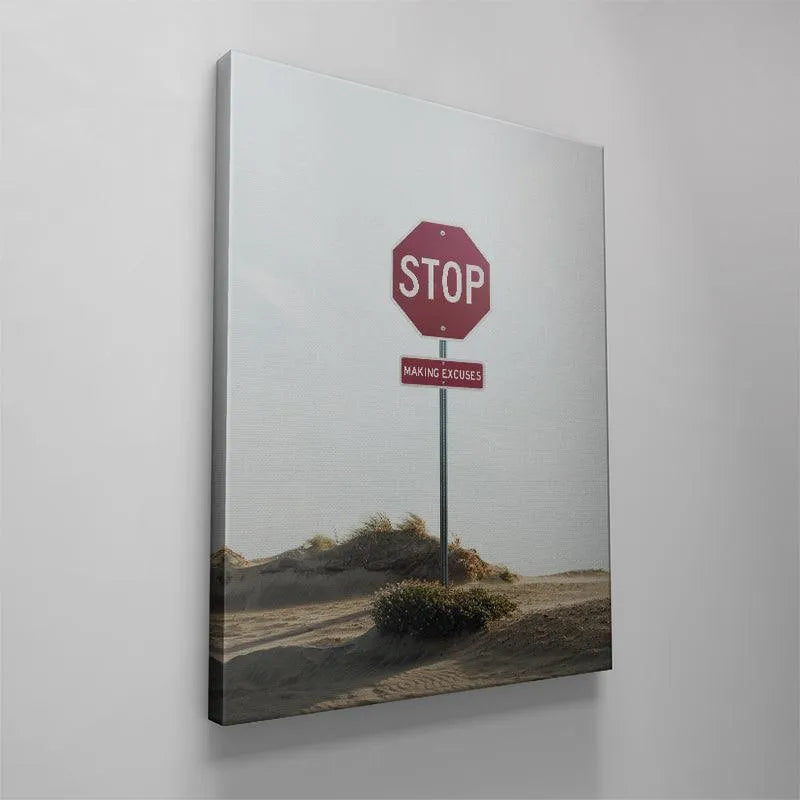 Modern office decor displaying the framed 'Stop Making Excuses' artwork hanging on a clean white wall, promoting productivity.