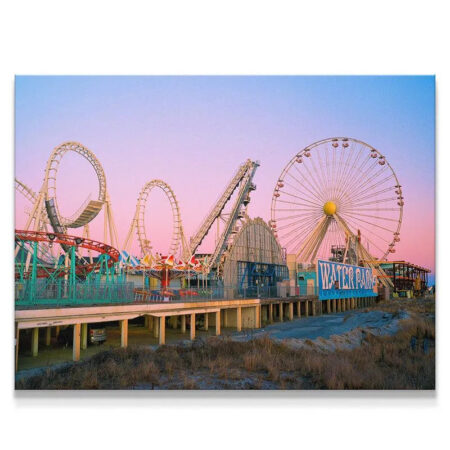 Wide shot of the boardwalk rides at sunset for Summers Down the Shore, showcasing the entire pier.