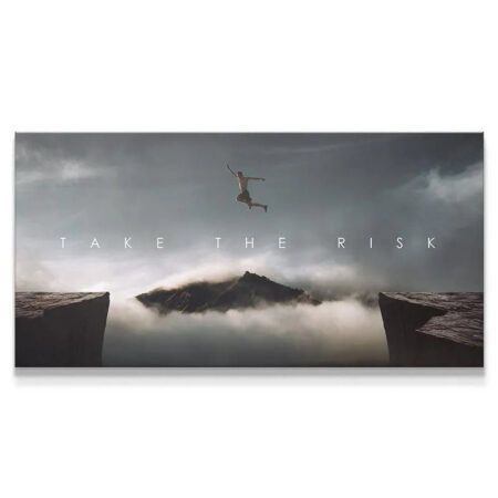 Panoramic view of the cliff jumper against the dark, cloudy sky featured in the 'Take The Risk (Jump)' artwork.