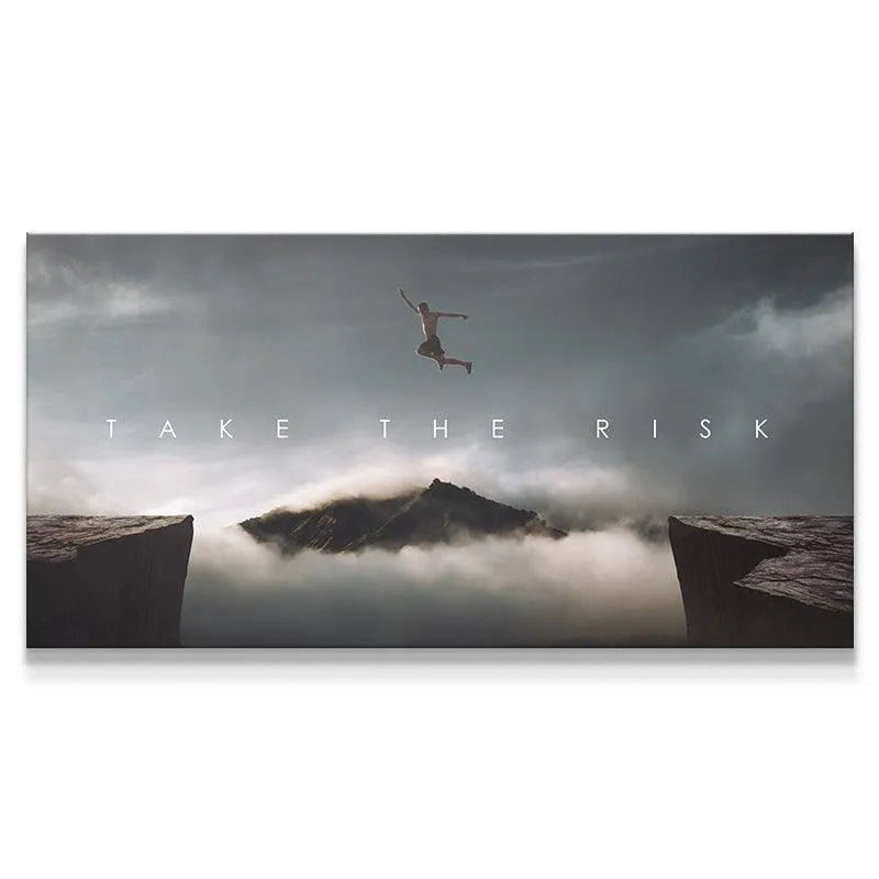 Panoramic view of the cliff jumper against the dark, cloudy sky featured in the 'Take The Risk (Jump)' artwork.