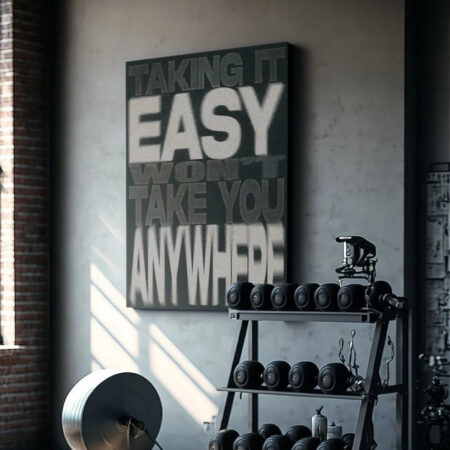 Wide shot of the industrial gym setting featuring the 'Taking It Easy' motivational canvas art above the dumbbell rack.