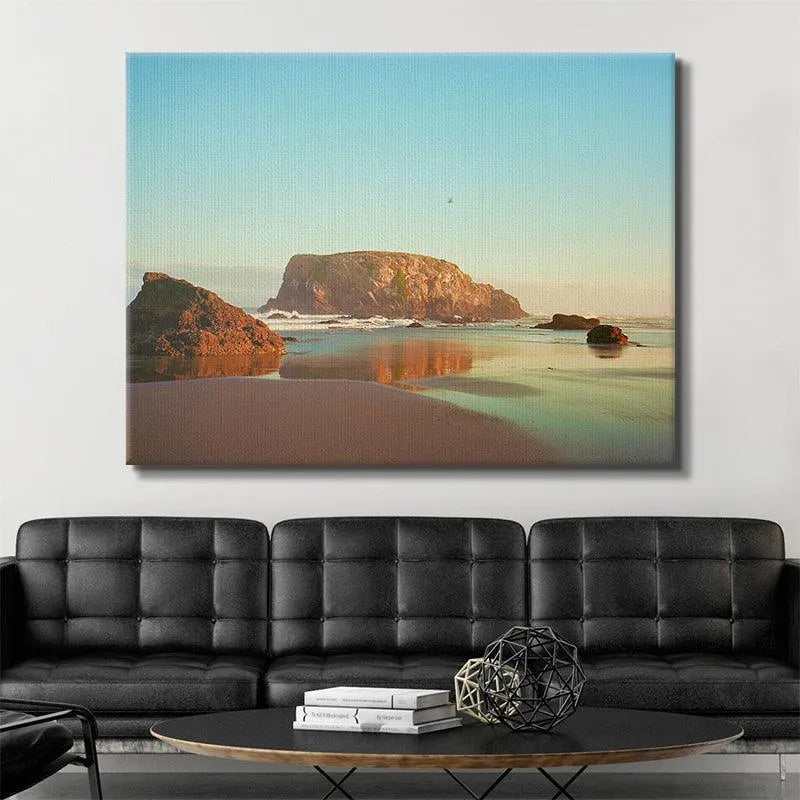 Golden hour lighting casting deep orange and yellow tones across the water and sand in the famous scene, 'The Bird from Bandon'.