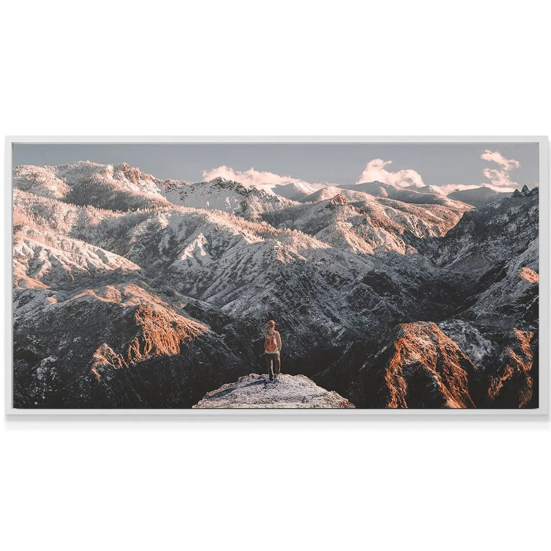 A lone hiker standing on a summit edge looking at the vast landscape, defining The Climb (No Quote).