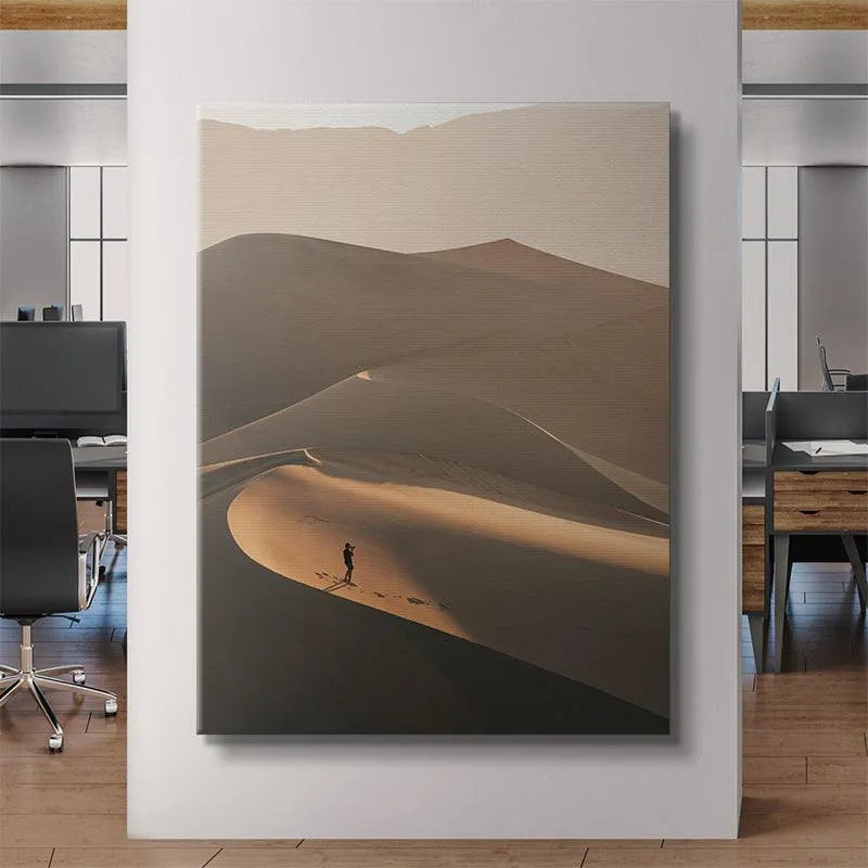 Angular perspective of the lone figure standing on the steep ridge in 'The Distant Viewer' artwork.
