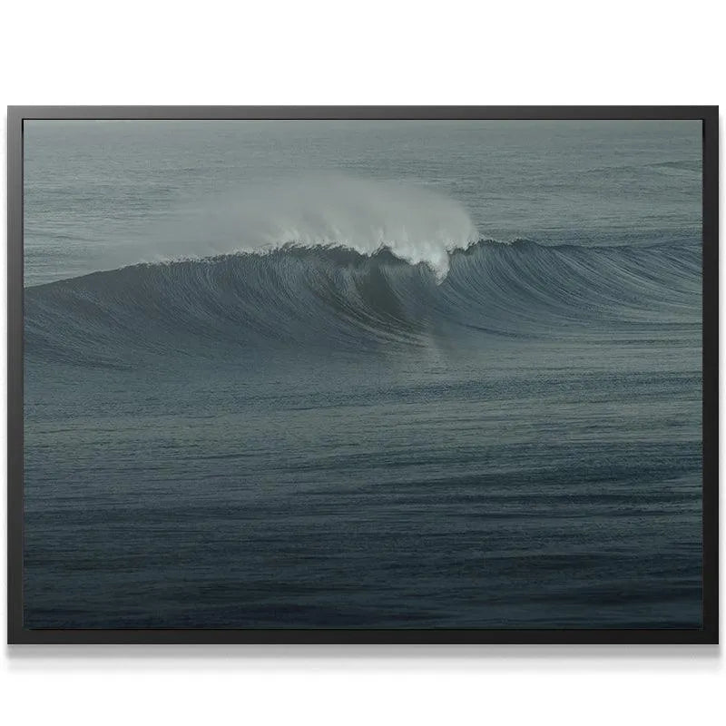 Wide-angle view showing the entire dramatic sweep of "The Glass Curl" wave against the flat horizon.
