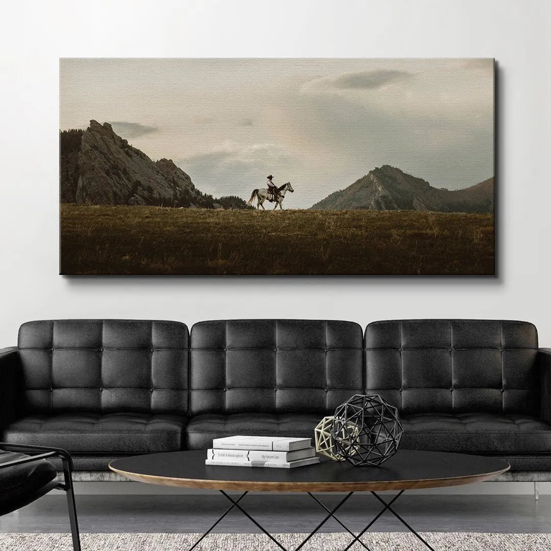 Full landscape shot showcasing the massive scale of the western mountains behind The Lone Rider.