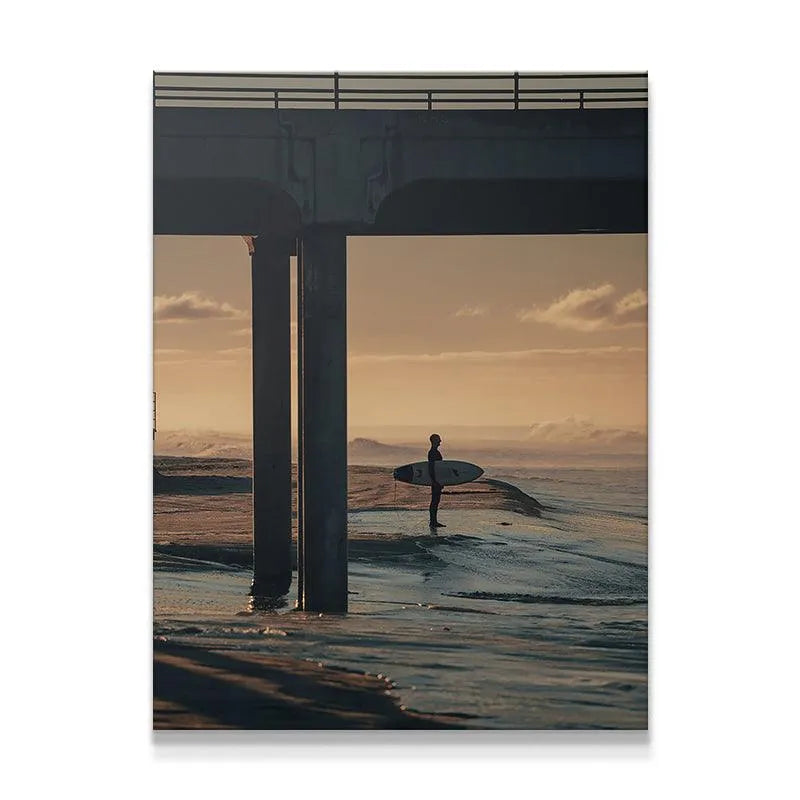 Full vertical photographic print showing a surfer silhouette under concrete pier structure in 'The Morning Wait'.