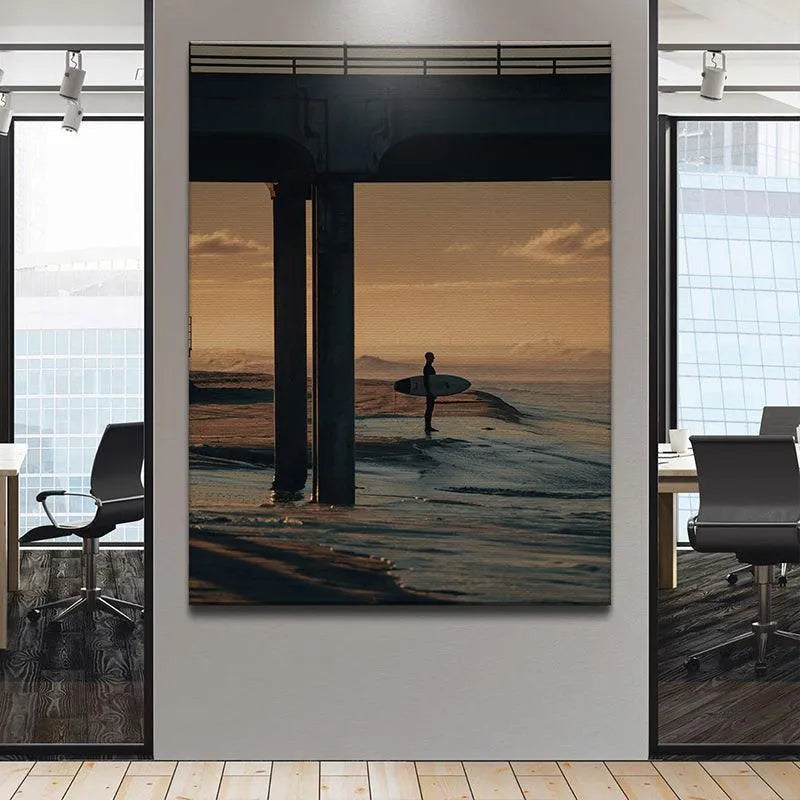 Industrial concrete bridge structure framing the coastal scene and surfer in 'The Morning Wait' art piece.