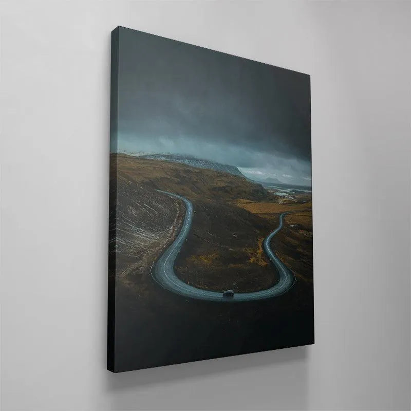Wide environmental shot capturing the dramatic scale of 'The Road Less Traveled' landscape and distant river.