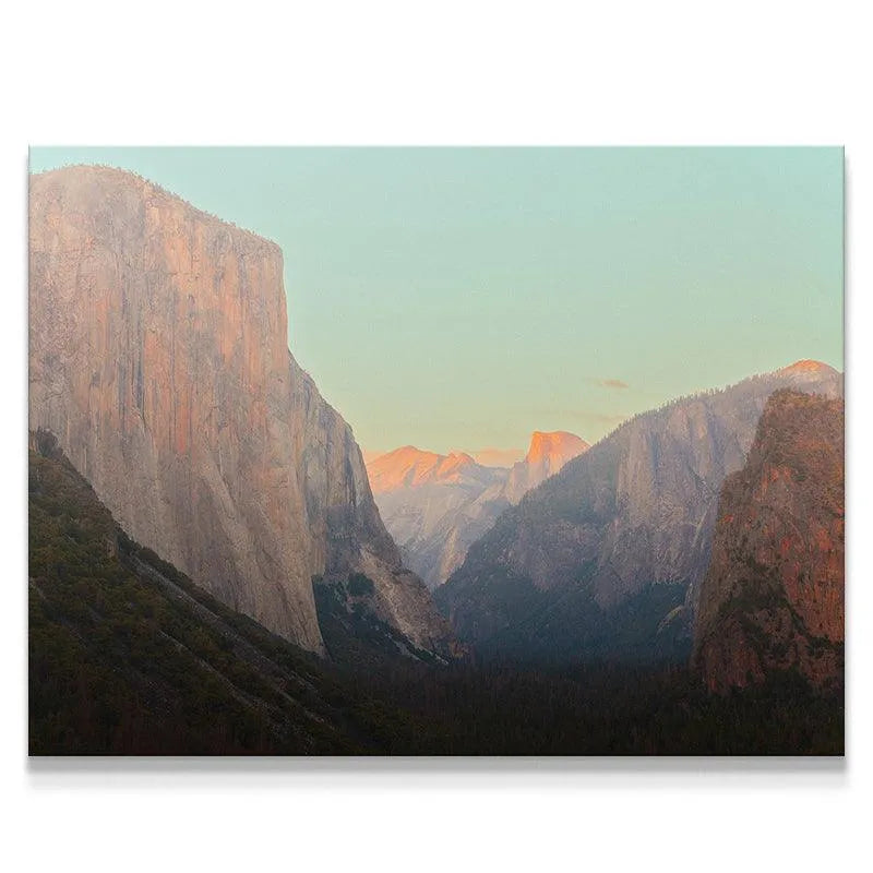 Wide landscape view of Yosemite Valley from The Tunnel viewpoint at sunrise.