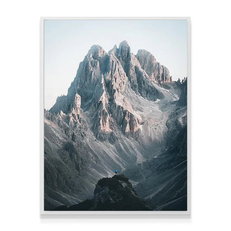 Aerial angle perspective of the hiker standing below the towering Three Peaks formation.