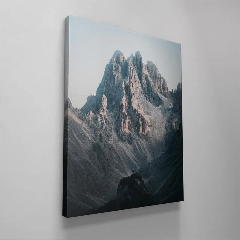 Pale, soft lighting highlighting the grey and pink hues in the Three Peaks rock faces.