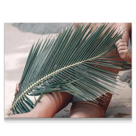 Close-up of the textured palm frond concealing the subject on the Topless Beach.