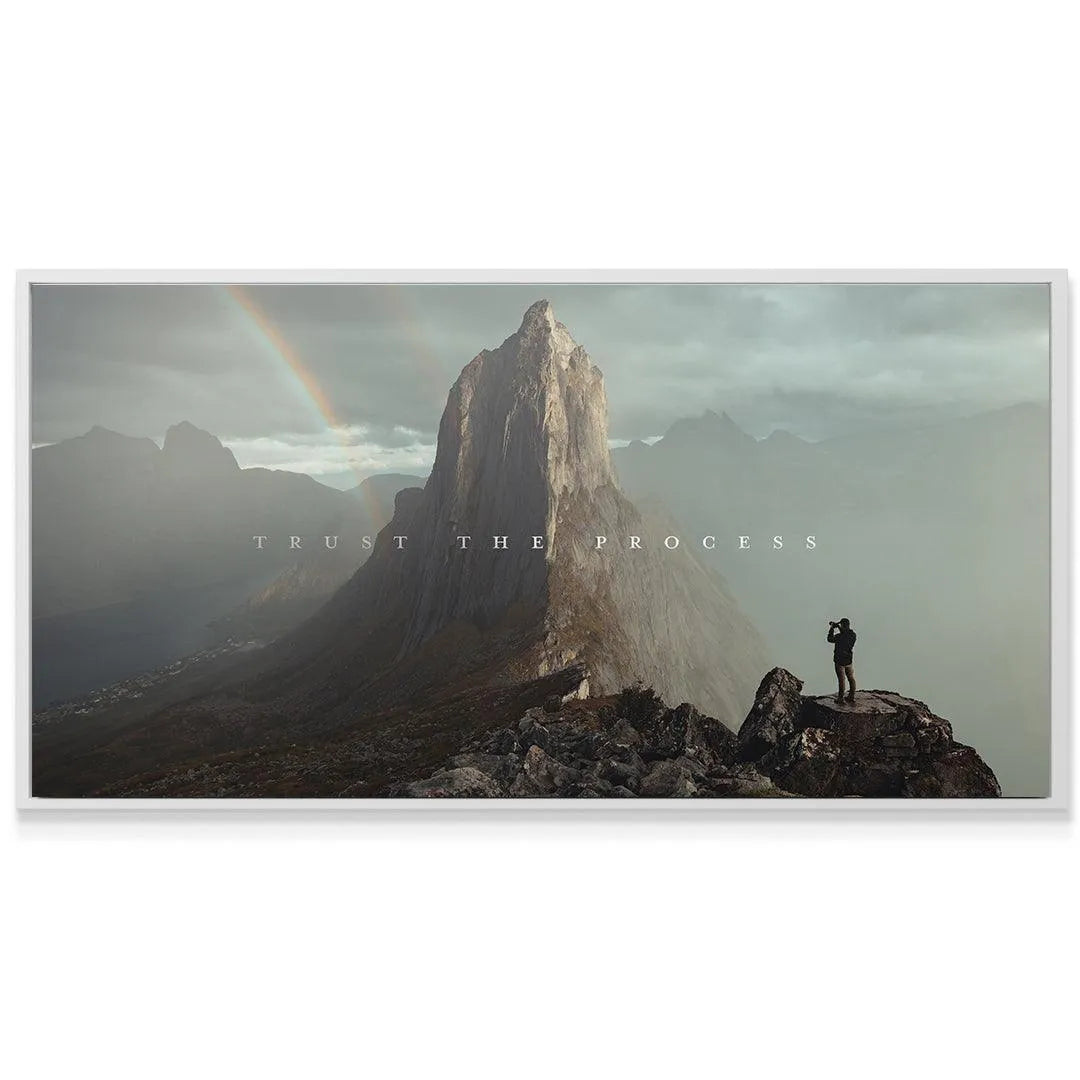 Detailed view of the lone photographer figure standing on the cliff edge in the 'Trust The Process' artwork.