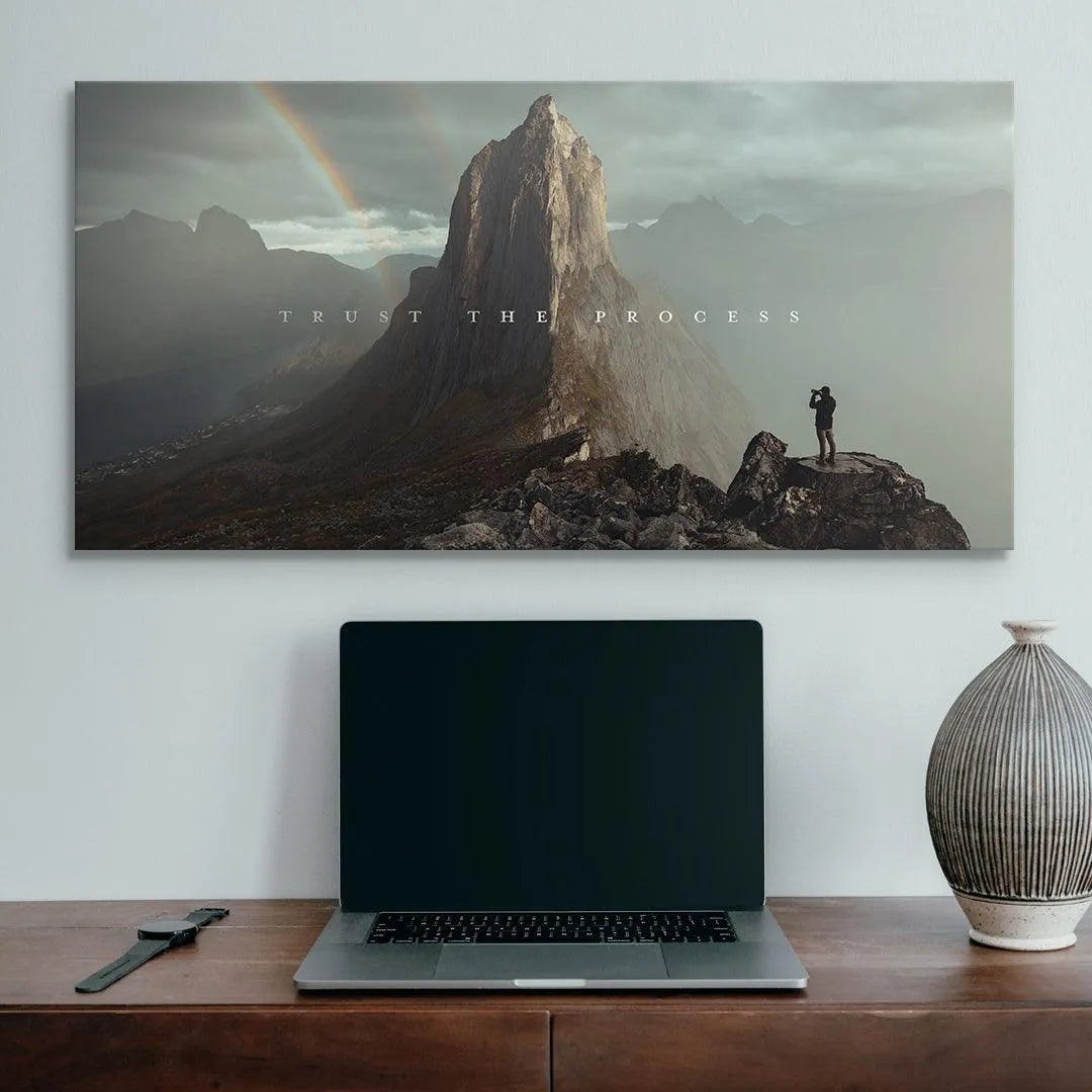 Atmospheric shot of the faint rainbow and mist surrounding the peaks on the 'Trust The Process' wall art.