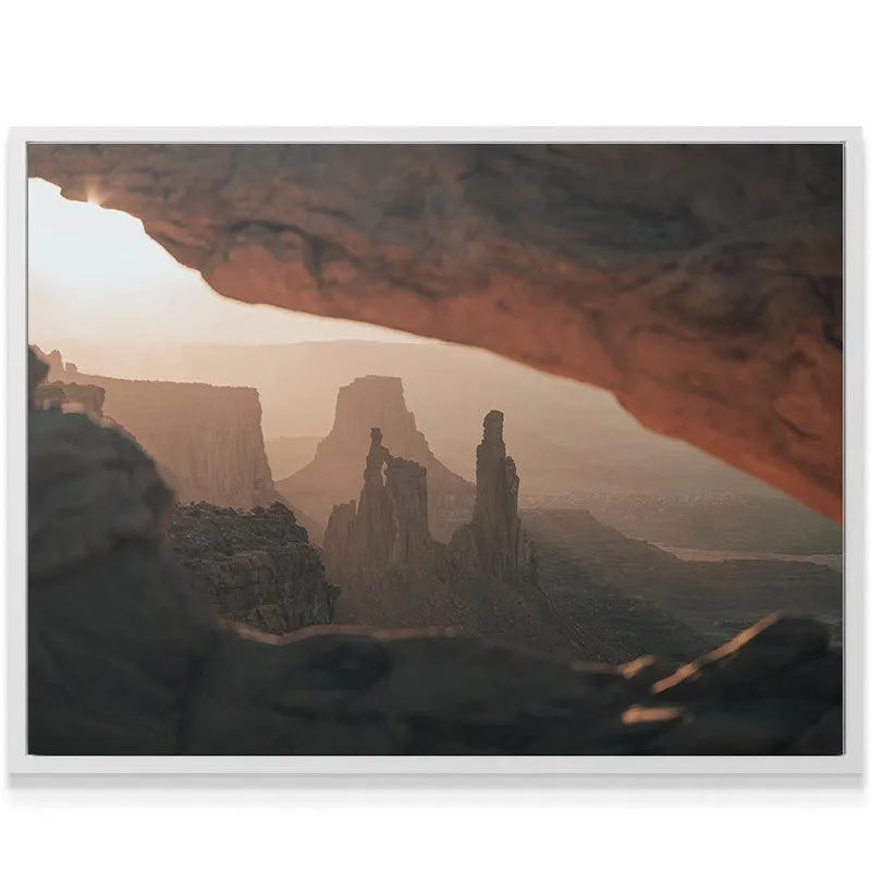 A vertical shot emphasizing the tall hoodoo rock formations seen Under the Glow of golden light.