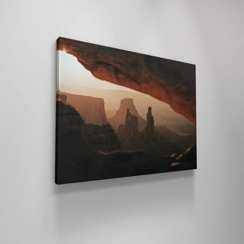 Low angle perspective highlighting the contrast between the dark foreground rock and the bright background, emphasizing Under the Glow.