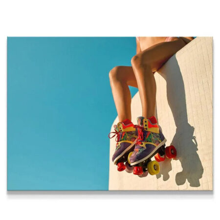 Close-up view of colorful roller skates worn by a woman sitting down at Venice Boardwalk.